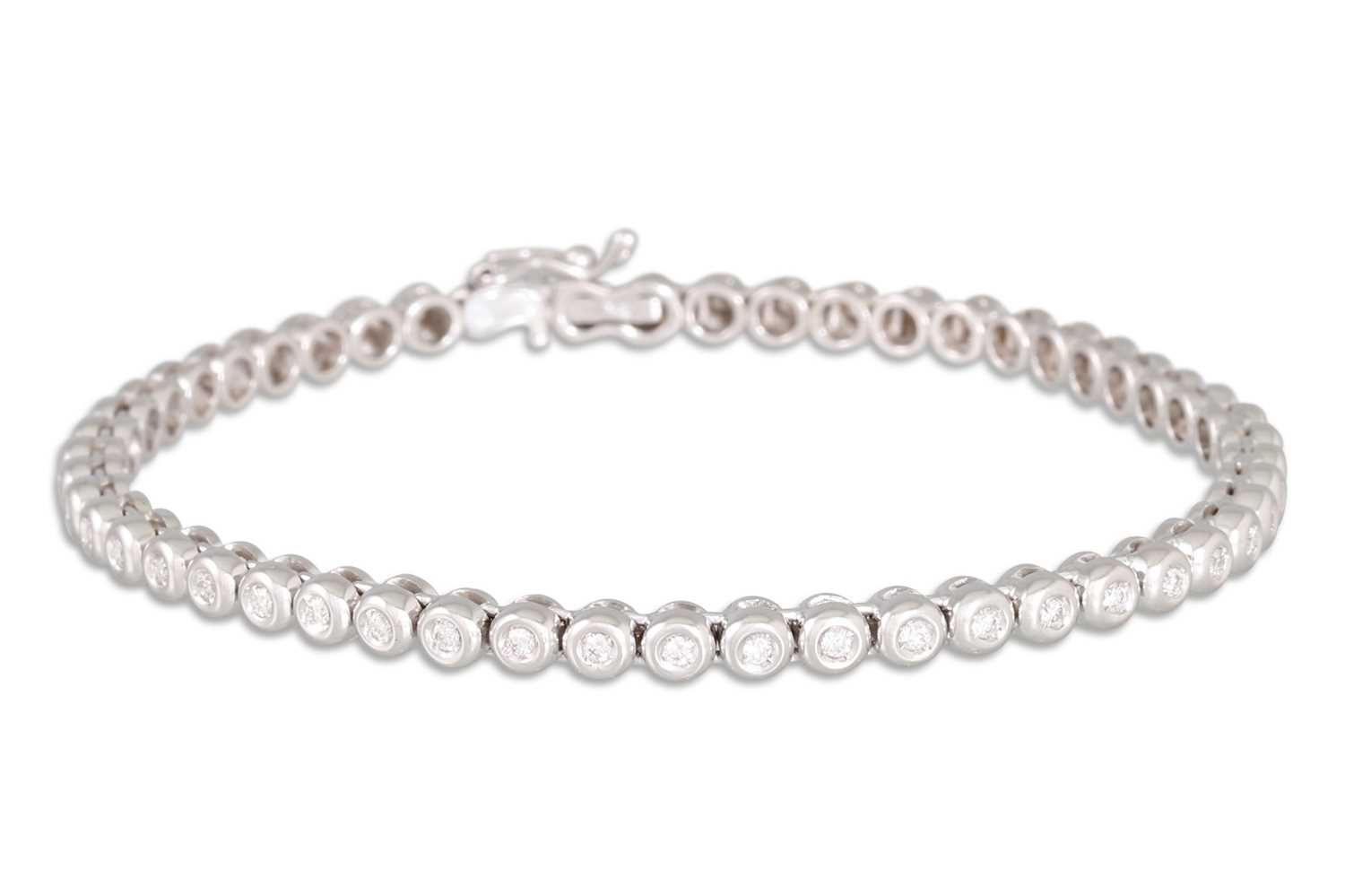 Lot 151 - A DIAMOND LINE BRACELET, the brilliant cut...