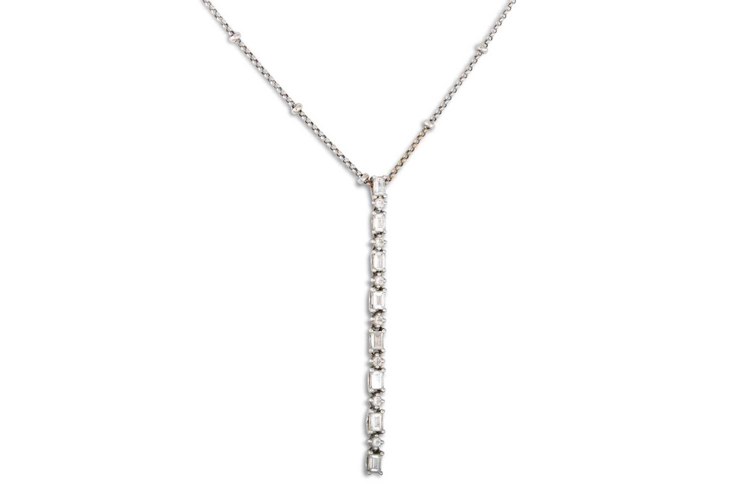 Lot 178 - A DIAMOND SET PENDANT, set with a line of...