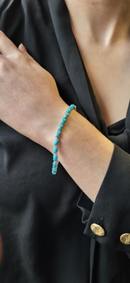 Lot 88 - A TURQUOISE AND DIAMOND LINE BRACELET, mounted...