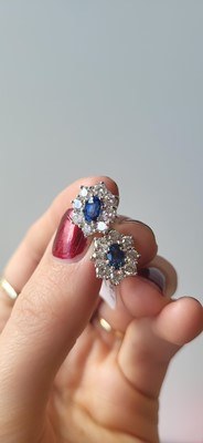Lot 207 - A PAIR OF DIAMOND AND SAPPHIRE CLUSTER...