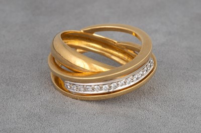 Lot 42 - A DIAMOND CROSS-OVER BAND RING, mounted in...