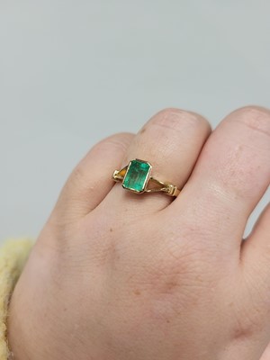 Lot 57 - AN EMERALD SINGLE STONE RING, the emerald cut...