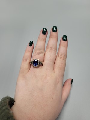 Lot 256 - A TANZANITE AND DIAMOND CLUSTER RING, the...