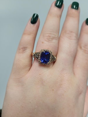 Lot 256 - A TANZANITE AND DIAMOND CLUSTER RING, the...