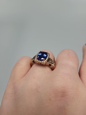 Lot 256 - A TANZANITE AND DIAMOND CLUSTER RING, the...