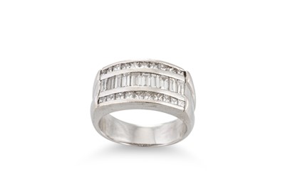 Lot 172 - A DIAMOND THREED ROWED RING, the channel set...