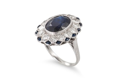 Lot 247 - A SAPPHIRE AND DIAMOND CLUSTER RING, the oval...