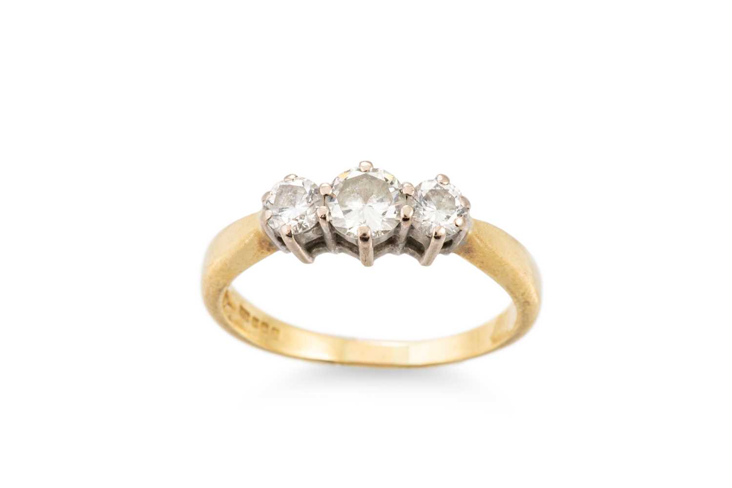 Lot 216 - A DIAMOND THREE STONE RING, the graduated...