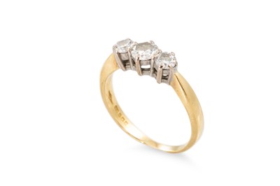 Lot 216 - A DIAMOND THREE STONE RING, the graduated...