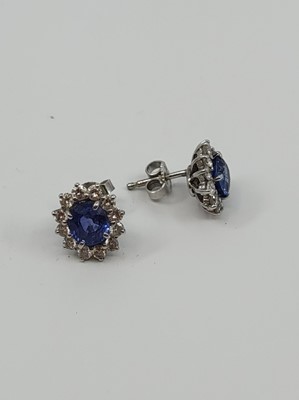 Lot 217 - A PAIR OF DIAMOND AND SAPPHIRE CLUSTER...