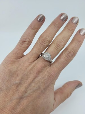 Lot 121 - A DIAMOND CLUSTER RING, set with brilliant cut...