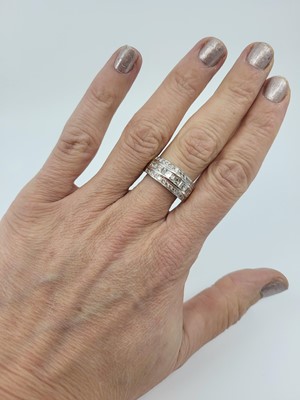 Lot 122 - A THREE ROWED DIAMOND RING, the princess,...
