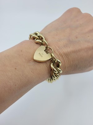 Lot 164 - A 9CT GOLD HEAVY CURB LINK BRACELET, padlock...