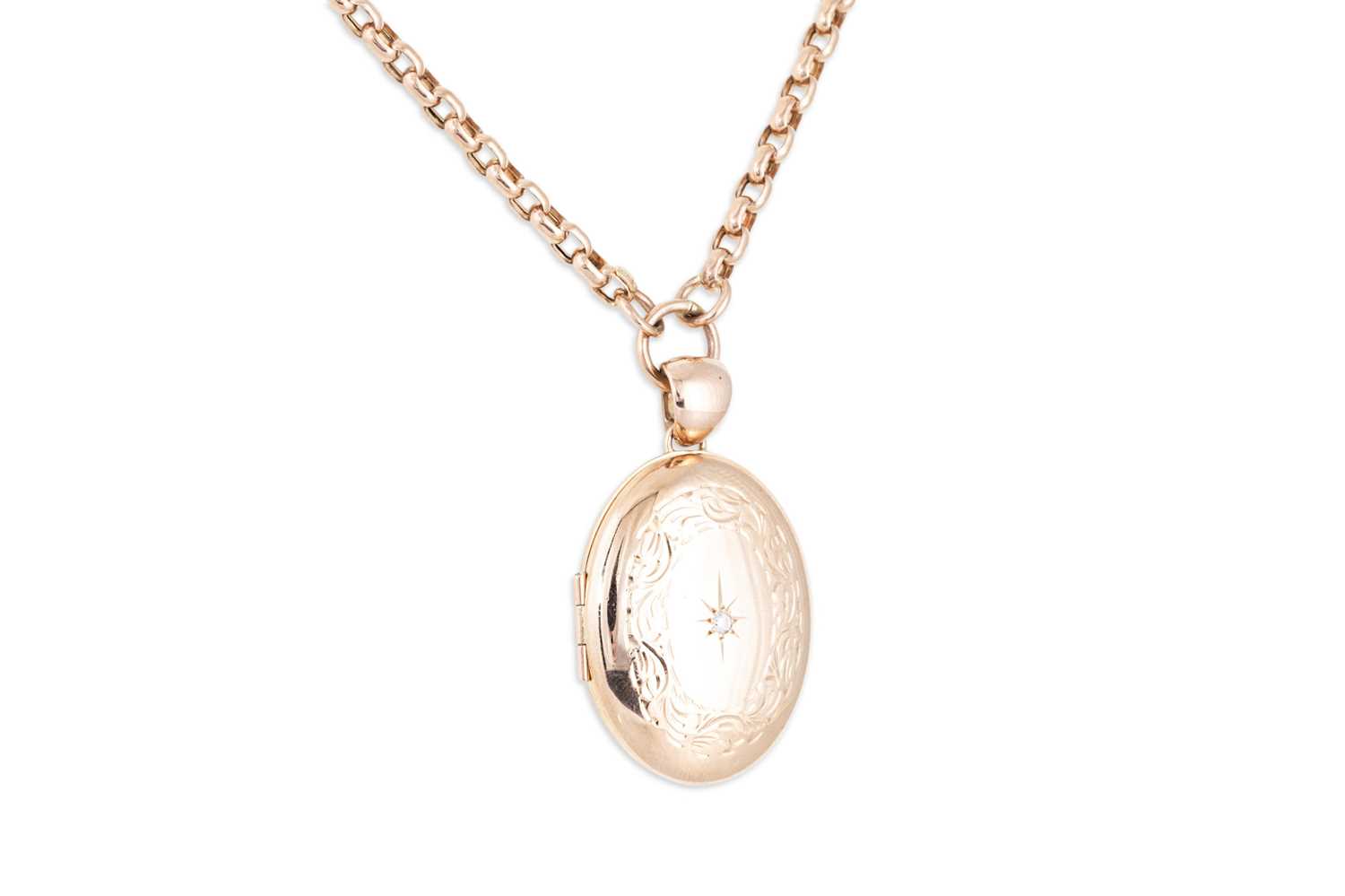 Lot 165 - A 9CT ROSE GOLD LOCKET, set with a diamond on...