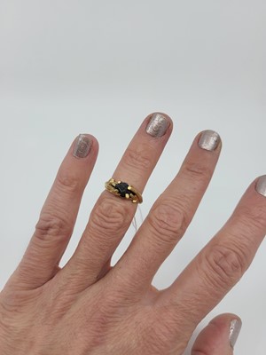 Lot 163 - A MOST UNUSUAL GOLD RING, the carved mount of...