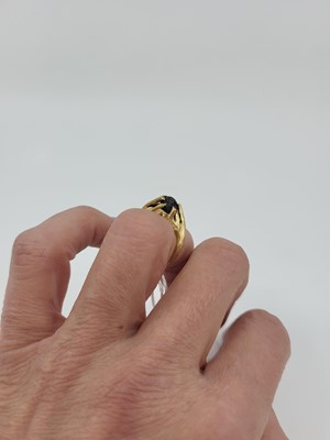 Lot 163 - A MOST UNUSUAL GOLD RING, the carved mount of...