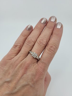 Lot 149 - A DIAMOND CLUSTER RING, set with princess cut...