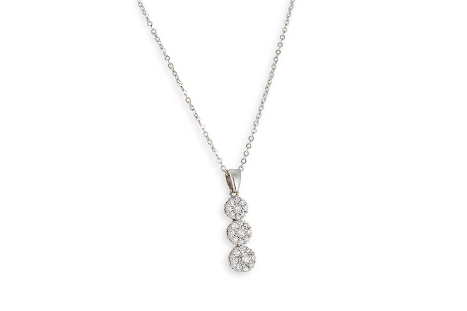 Lot 150 - A DIAMOND CLUSTER PENDANT, of triple cluster...