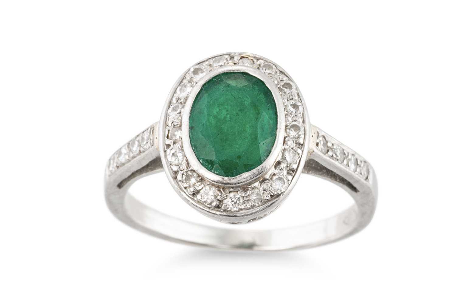 Lot 145 - AN EMERALD AND DIAMOND CLUSTER RING, the oval...
