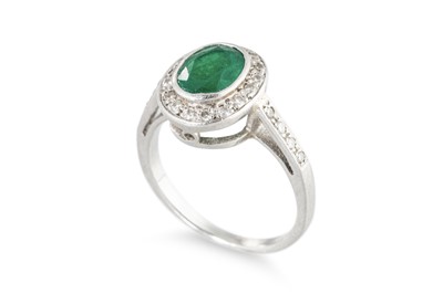 Lot 145 - AN EMERALD AND DIAMOND CLUSTER RING, the oval...