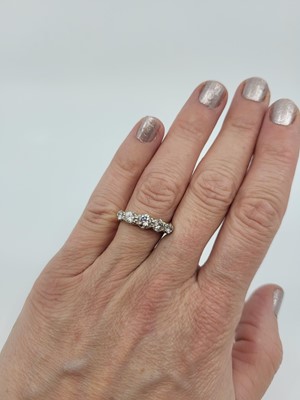 Lot 181 - A GRADUATED DIAMOND FIVE STONE RING, the round...