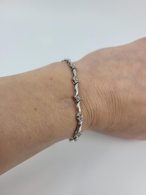 Lot 220 - A DIAMOND SET BRACELET, comprising a series of...