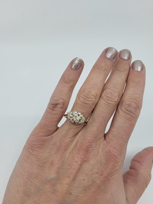 Lot 224 - A DIAMOND CLUSTER RING, set with two principal...