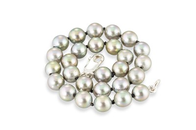 Lot 228 - A CULTURED PEARL BRACELET, grey with green...