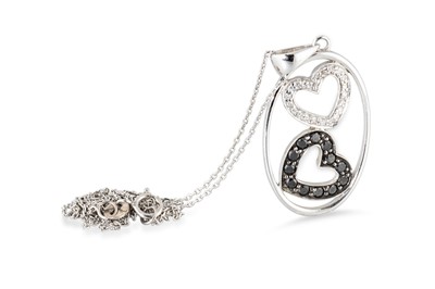 Lot 294 - A BLACK & WHITE DIAMOND LOVE HEART PENDANT, in...