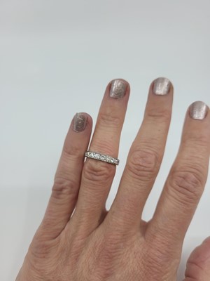 Lot 278 - A DIAMOND HALF ETERNITY RING, the brilliant...