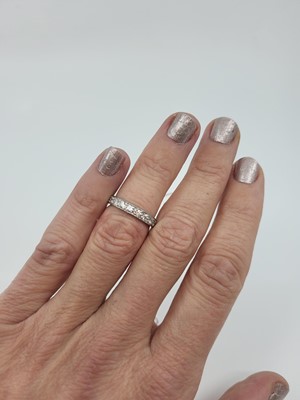 Lot 279 - A DIAMOND HALF ETERNITY RING, the brilliant...