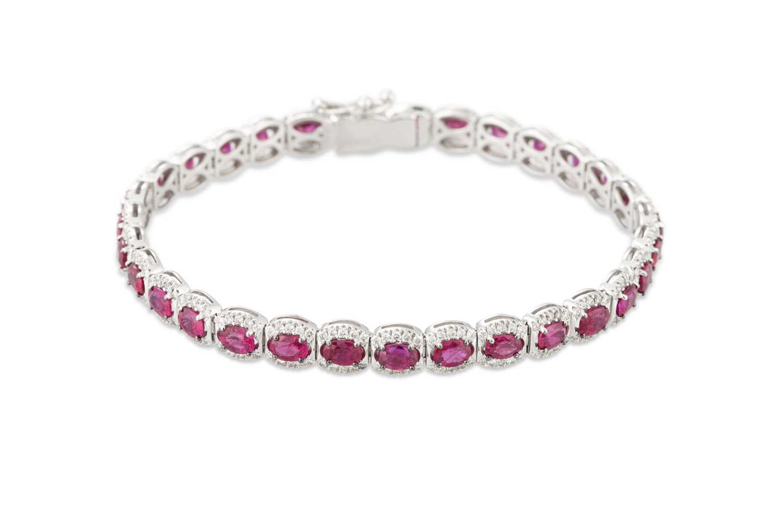 Lot 154 - A RUBY AND DIAMOND CLUSTER BRACELET, in 18ct...