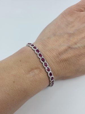 Lot 154 - A RUBY AND DIAMOND CLUSTER BRACELET, in 18ct...