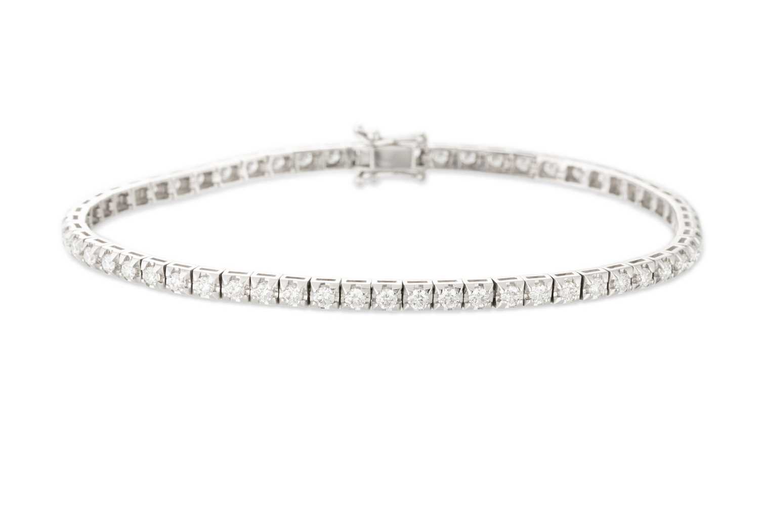 Lot 155 - A DIAMOND LINE BRACELET, the brilliant cut...