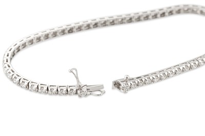Lot 155 - A DIAMOND LINE BRACELET, the brilliant cut...