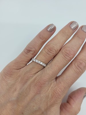 Lot 160 - A DIAMOND HALF ETERNITY RING, the brilliant...