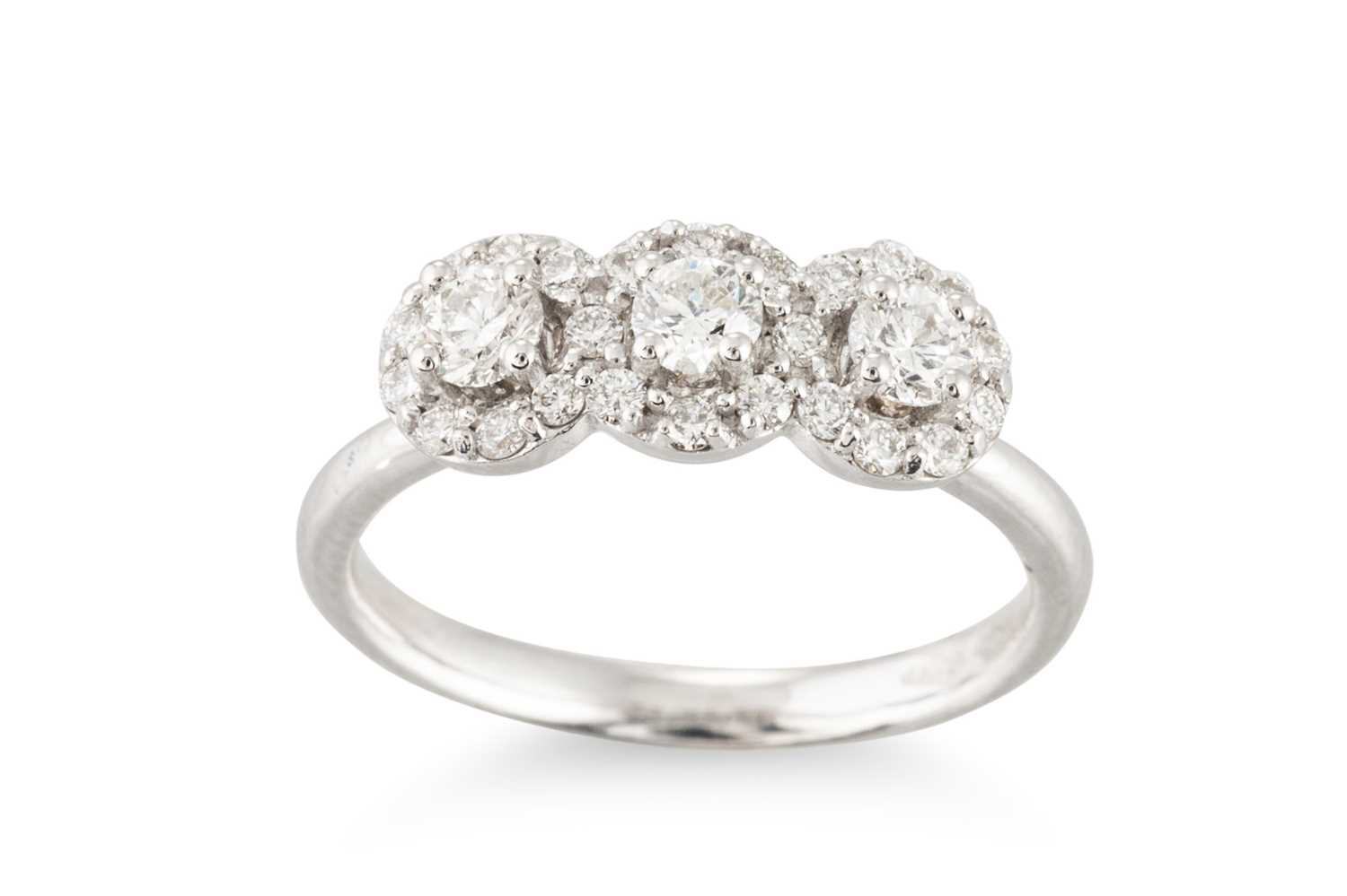 Lot 286 - A DIAMOND TRIPLE CLUSTER RING, the brilliant...