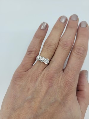 Lot 286 - A DIAMOND TRIPLE CLUSTER RING, the brilliant...