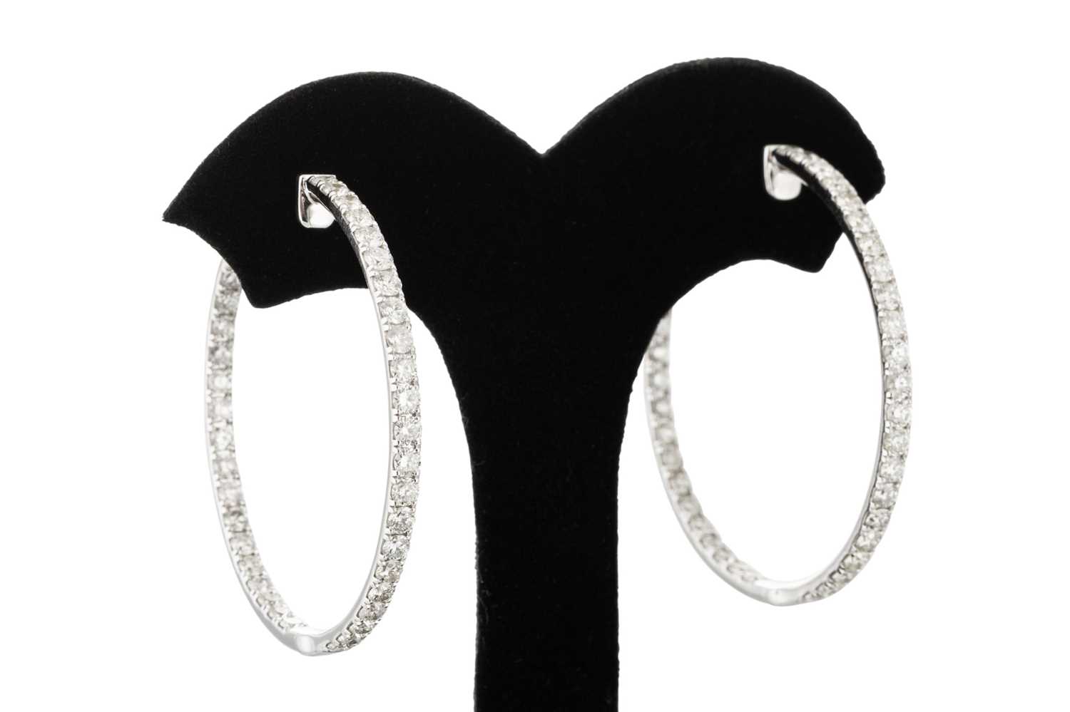 Lot 291 - A PAIR OF DIAMOND HOOP EARRINGS, the diamonds...