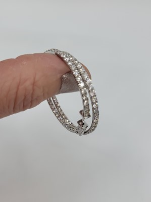 Lot 291 - A PAIR OF DIAMOND HOOP EARRINGS, the diamonds...