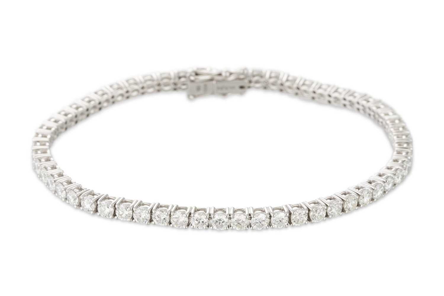 Lot 333 - A DIAMOND LINE BRACELET, the brilliant cut...