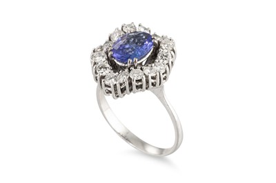 Lot 182 - A TANZANITE AND DIAMOND CLUSTER RING, the oval...