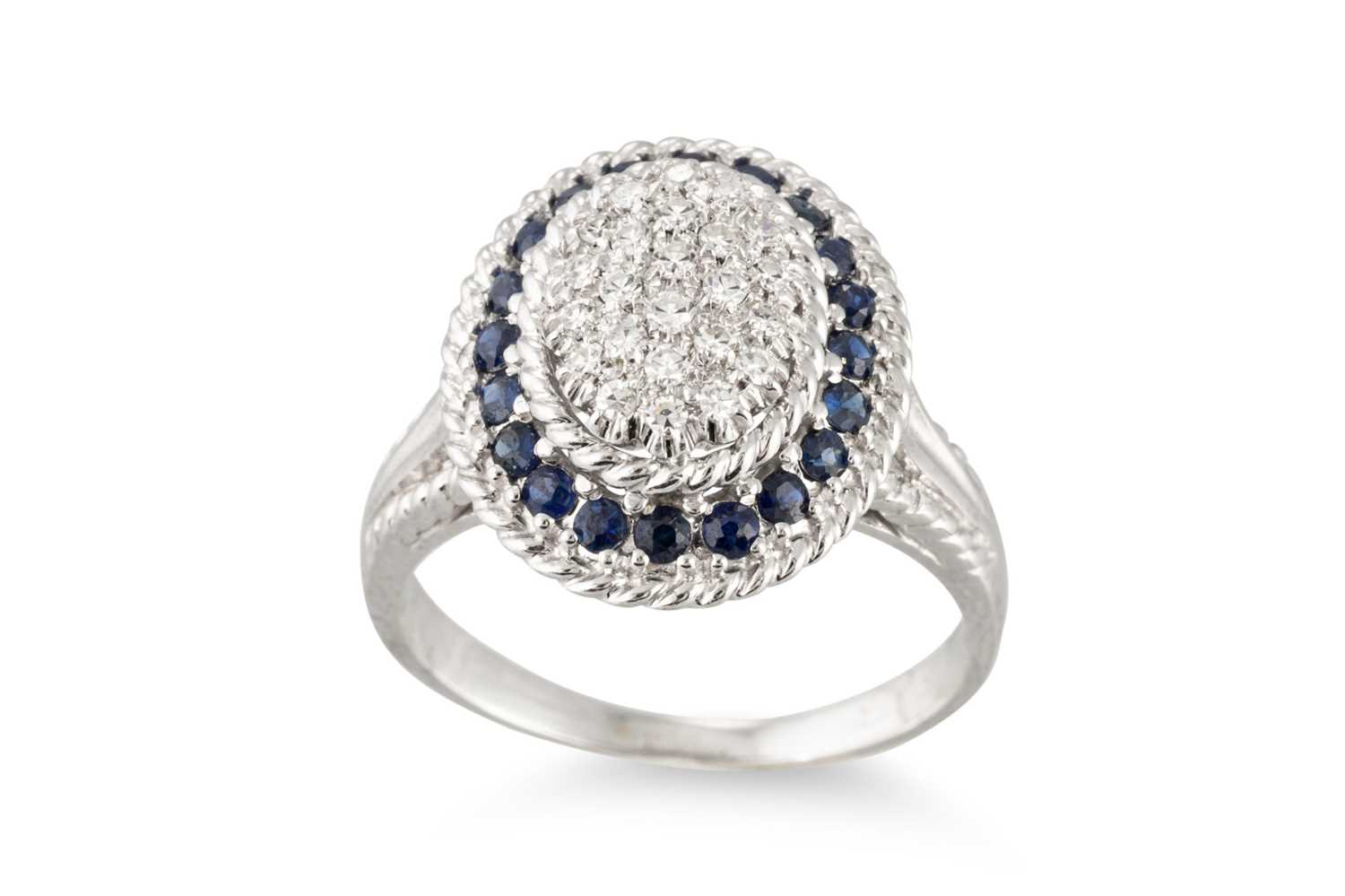 Lot 186 - A PAVÉ DIAMOND AND SAPPHIRE CLUSTER RING,...