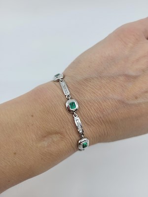 Lot 231 - AN EMERALD AND DIAMOND BRACELET, each...