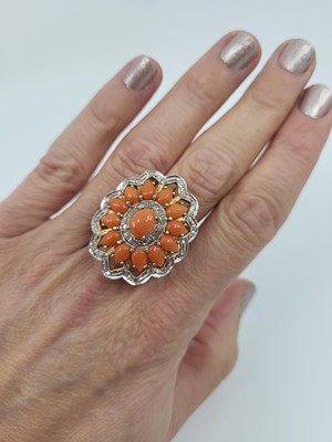 Lot 196 - A CORAL AND DIAMOND SET CLUSTER RING, the...