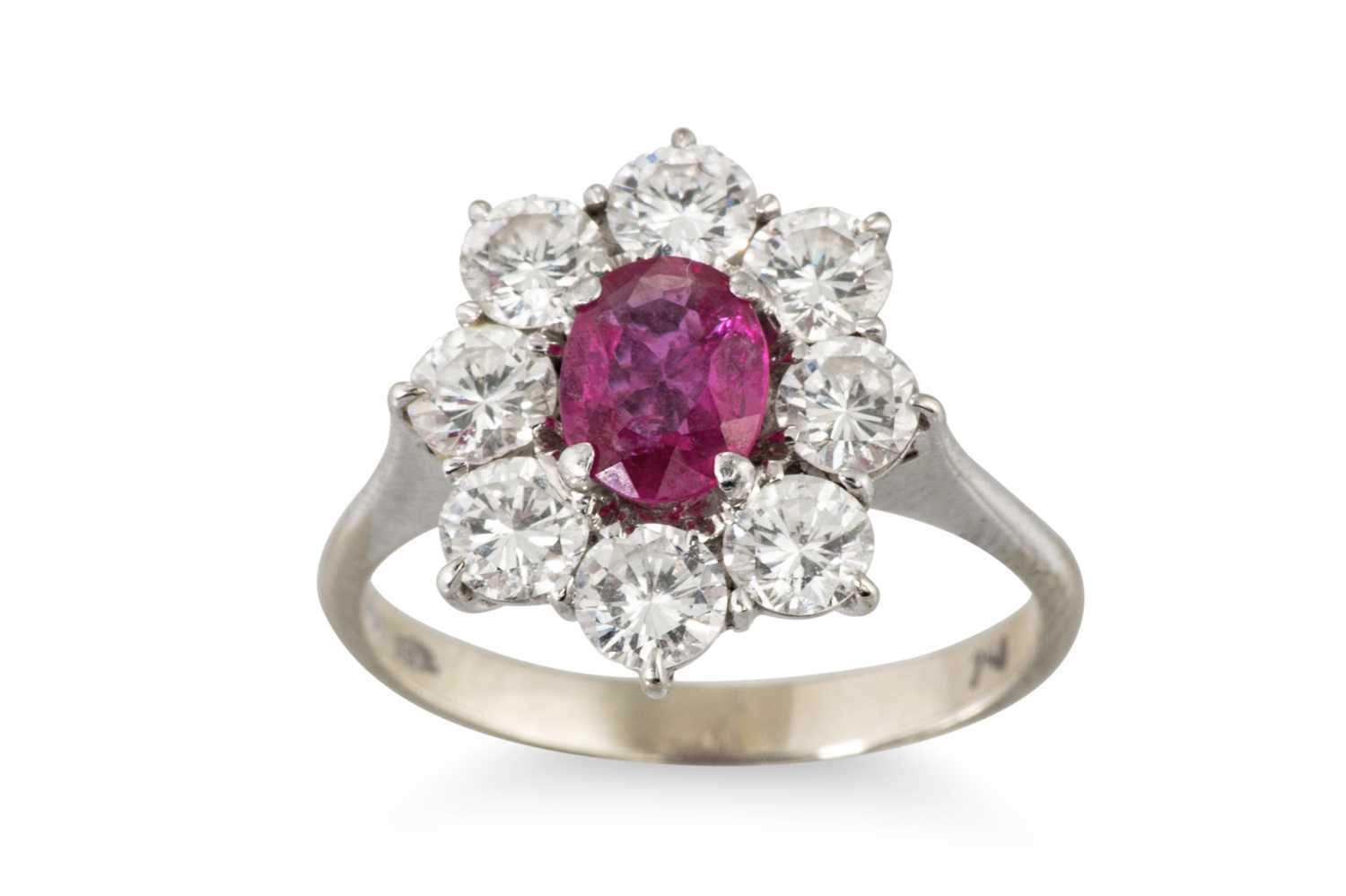 Lot 212 - A RUBY AND DIAMOND CLUSTER RING, the central...