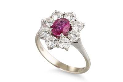 Lot 212 - A RUBY AND DIAMOND CLUSTER RING, the central...