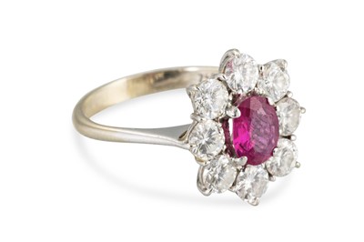 Lot 212 - A RUBY AND DIAMOND CLUSTER RING, the central...