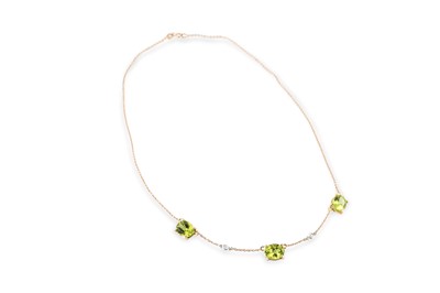 Lot 233 - A PERIDOT AND DIAMOND SET NECKLACE, the trio...