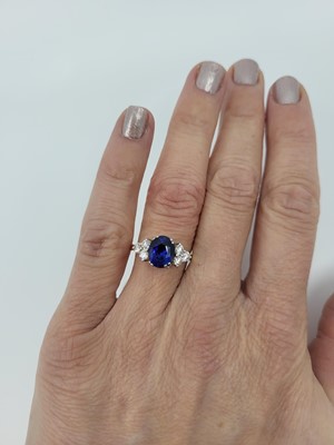 Lot 265 - A SAPPHIRE AND DIAMOND RING, the oval sapphire...